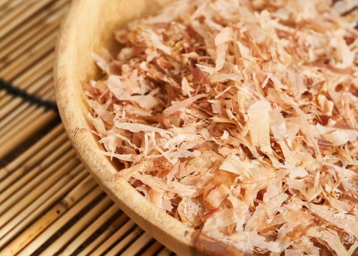 A wooden bowl of bonito flakes.